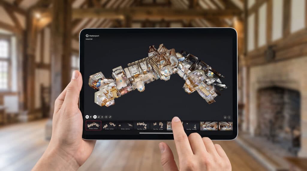 Museum curator using a tablet to review a 3D virtual tour funded by an Arts Council grant