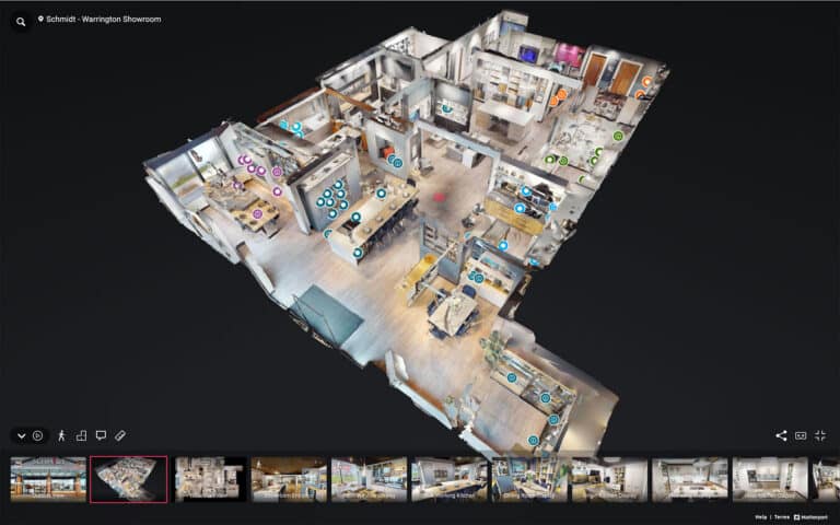 Close-up of a tablet screen displaying a Matterport 3D Dollhouse view of a multi-floor commercial office building.