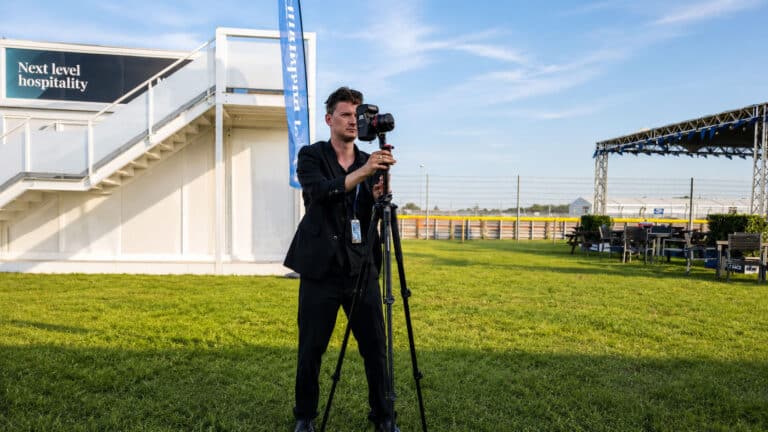 A professional photographer setting up a 360-degree camera on a tripod to capture a high-resolution virtual tour for a business profile.
